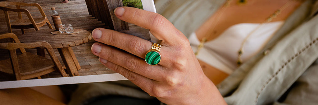 Woman reading wearing large malachite stone ring
