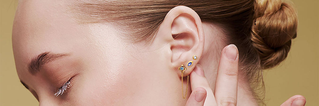WOMAN WEARING SINGLE EARRINGS