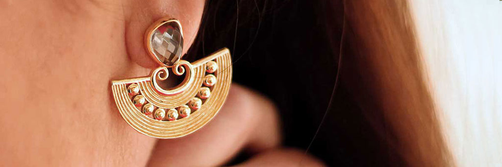 Statement gold earring on a model
