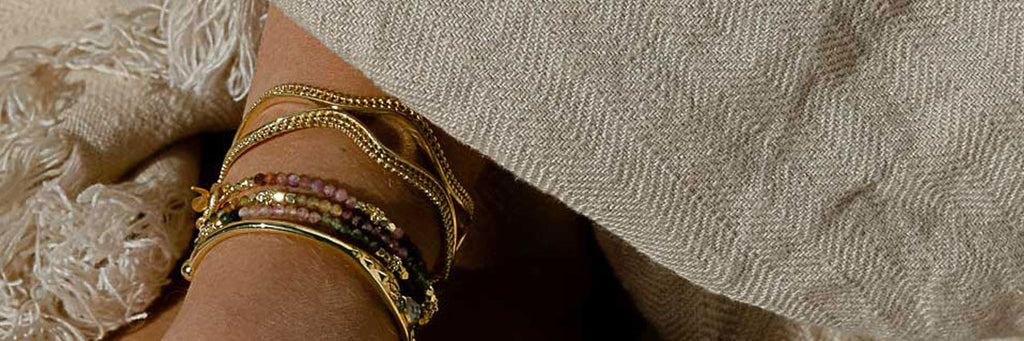 Woman wearing wide bangle and bracelets close up
