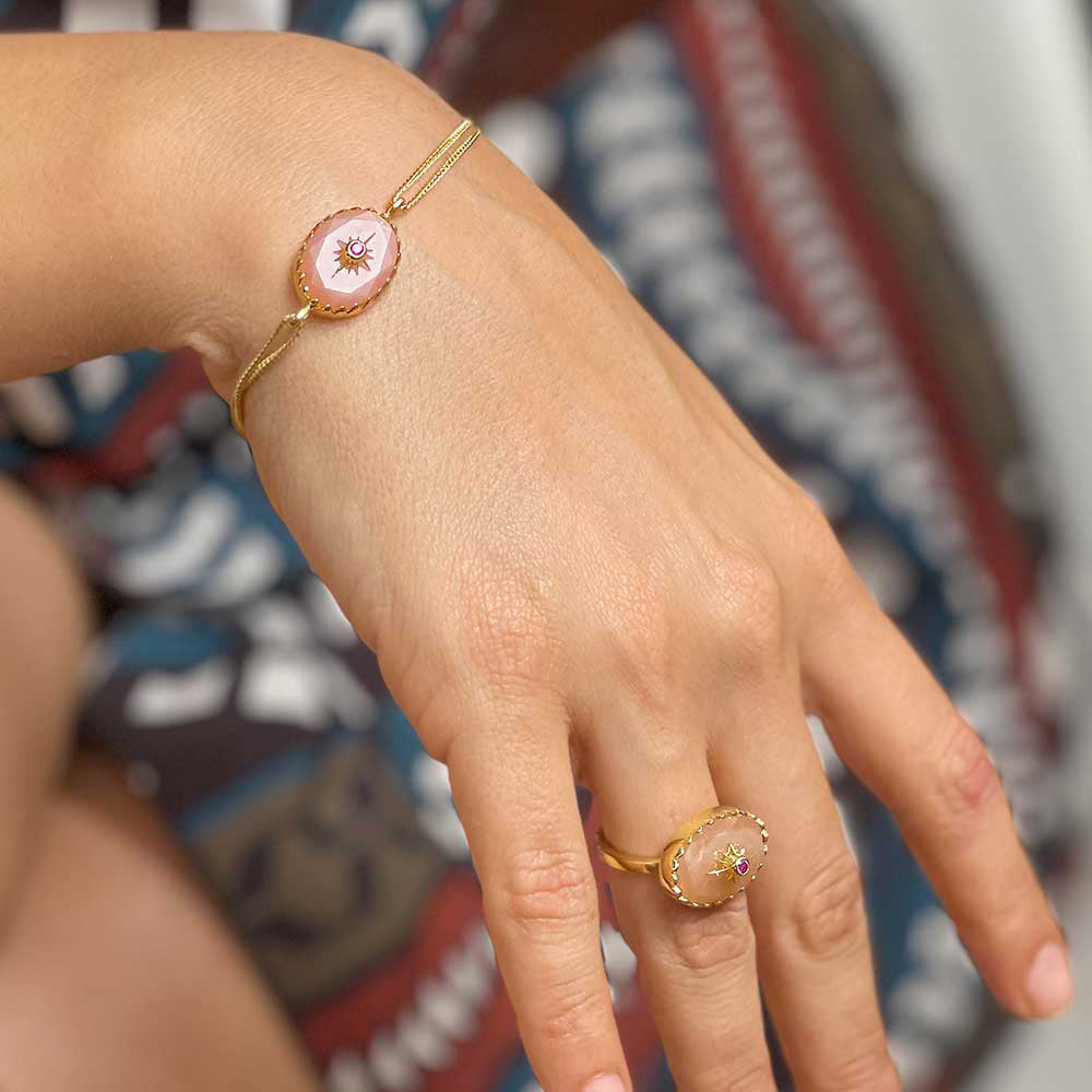 Model wears Oval Peach moonstone bracelet with double chain and slider toggle in gold vermeil  