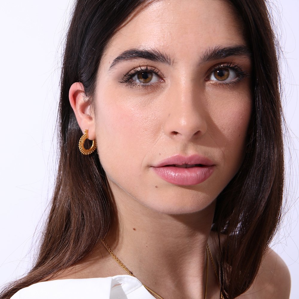 Model wearing Small gold bead hoop earrings, 18 karat yellow gold, by Azuni London