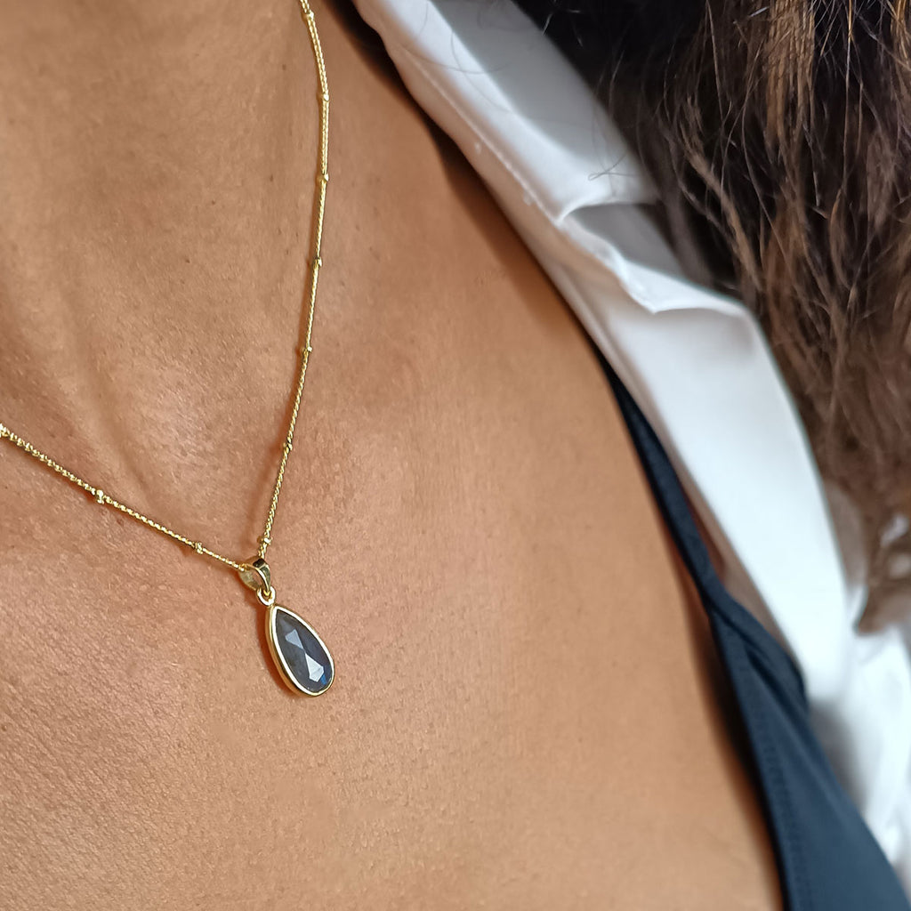 woman wearing labradorite gemstone necklace